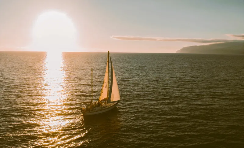 The classic ketch Spica sailing at sunset