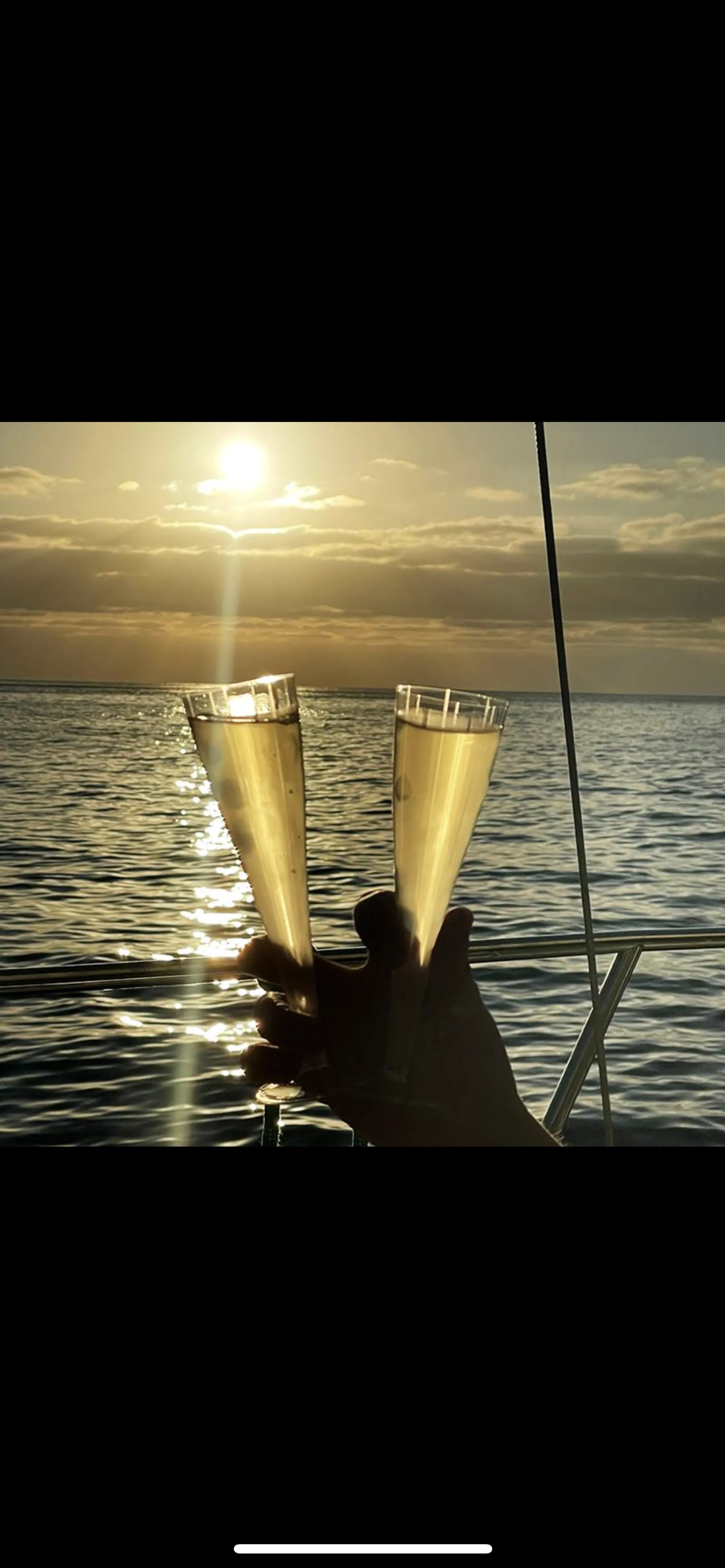 A toast with sparkling wine on deck at golden hour