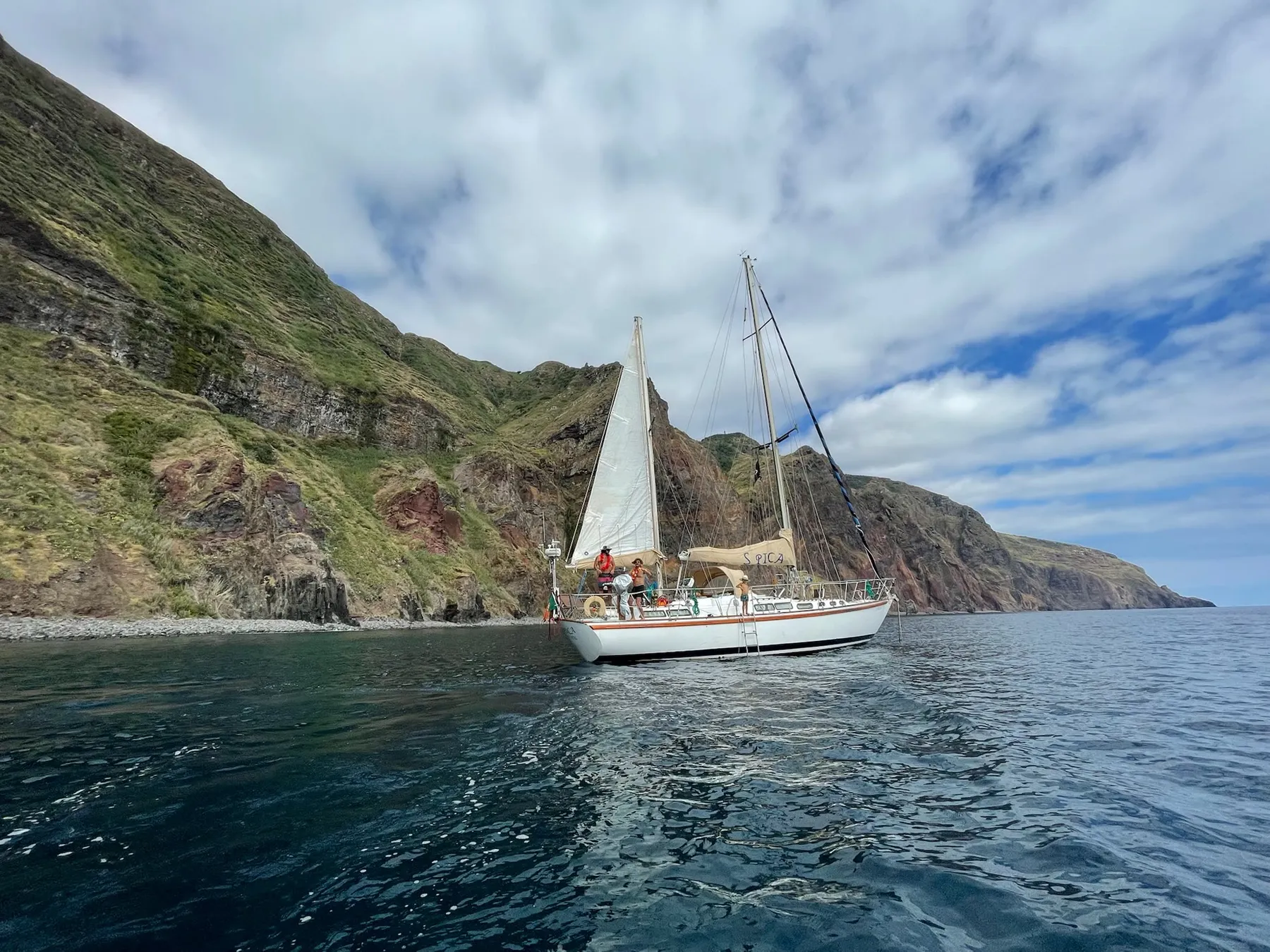 Spica close to the green cliffs of the Madeira coast